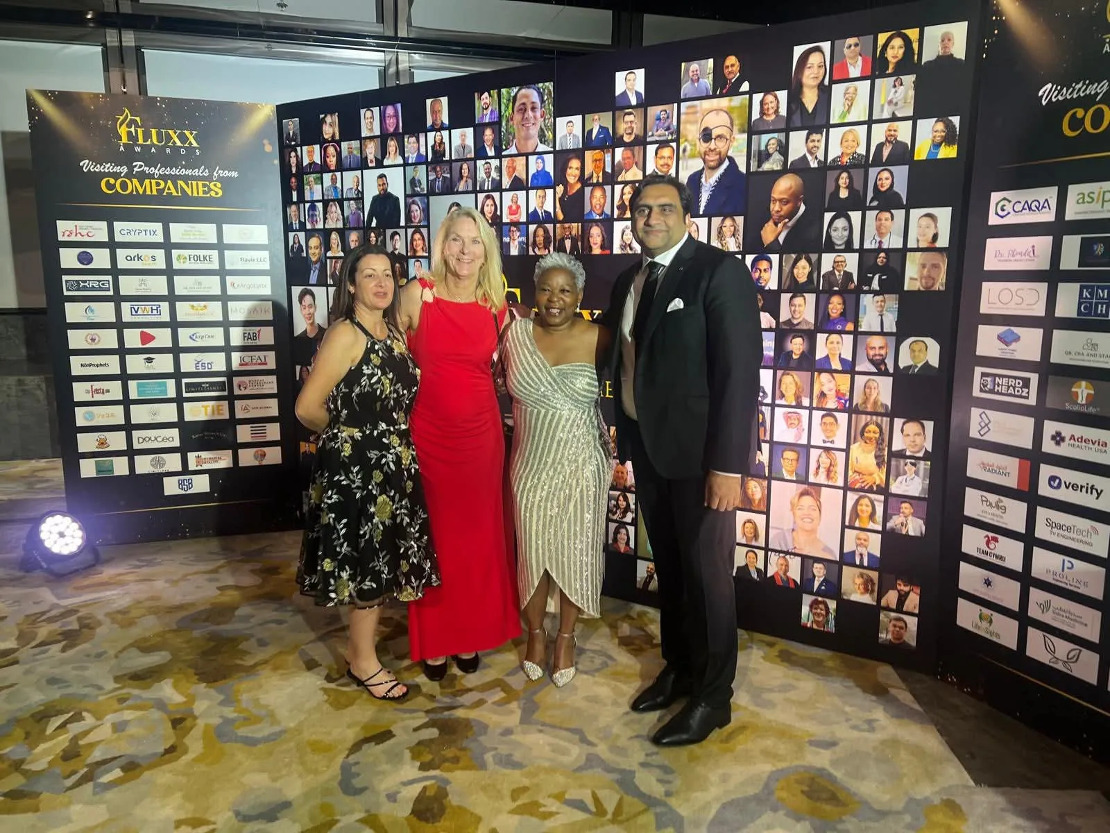 Sukh Sandhu with colleagues at the FLUXX Awards, showcasing professional development and global connections.