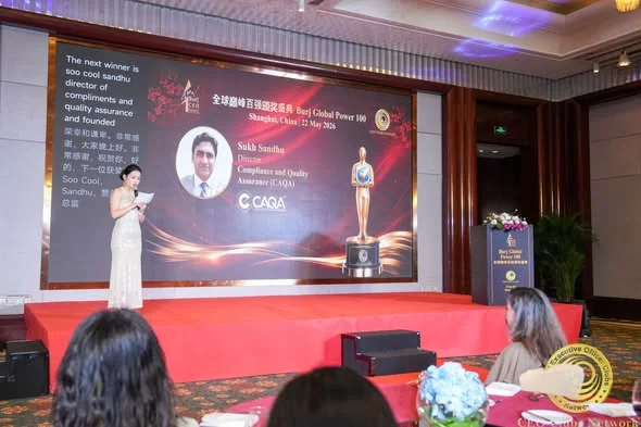 Sukh Sandhu receives the Burj Global Power 100 award on stage in Shanghai, recognised for quality assurance.