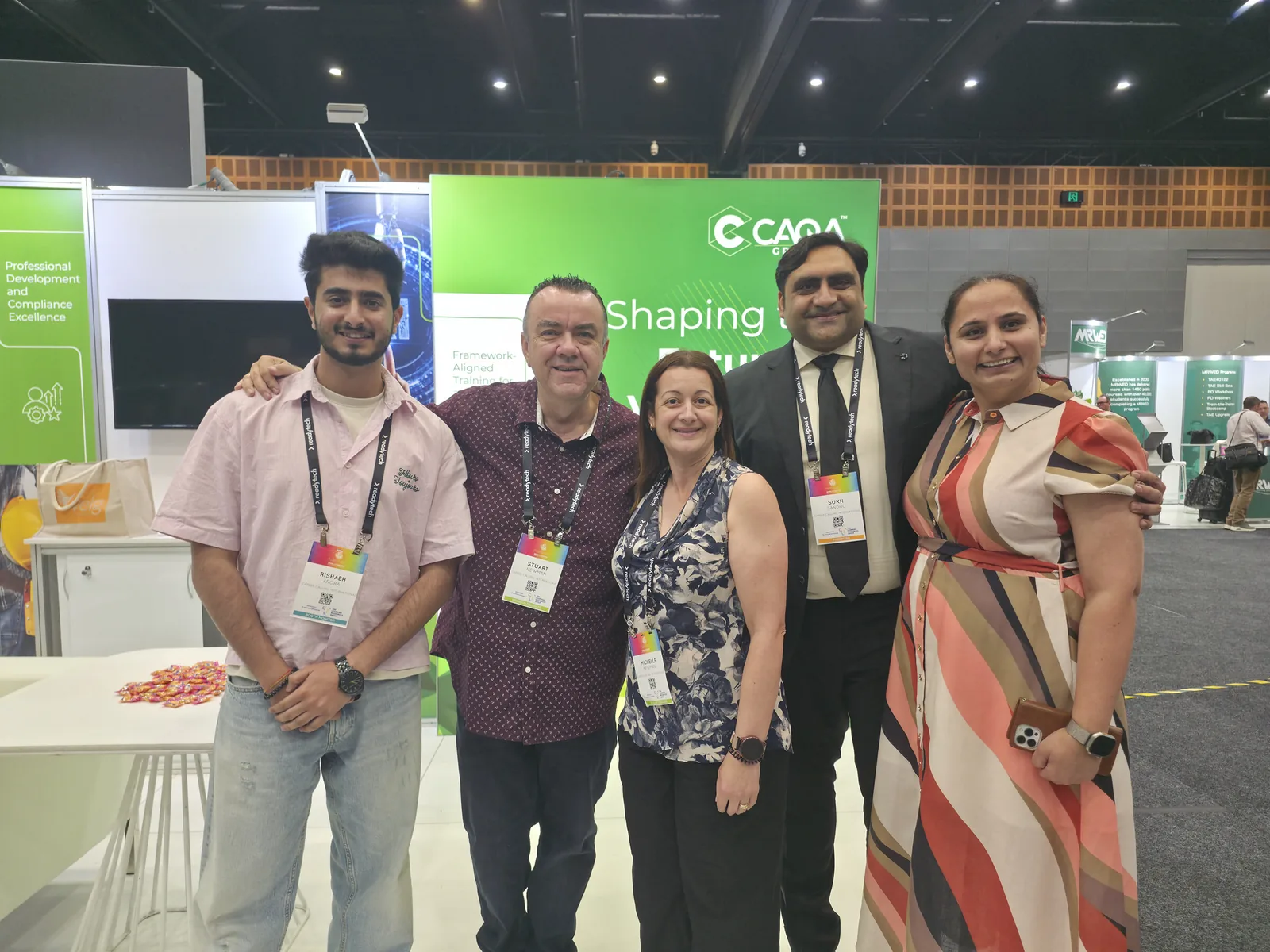 Sukh Sandhu with the team at the CAQA stand during a professional development event.