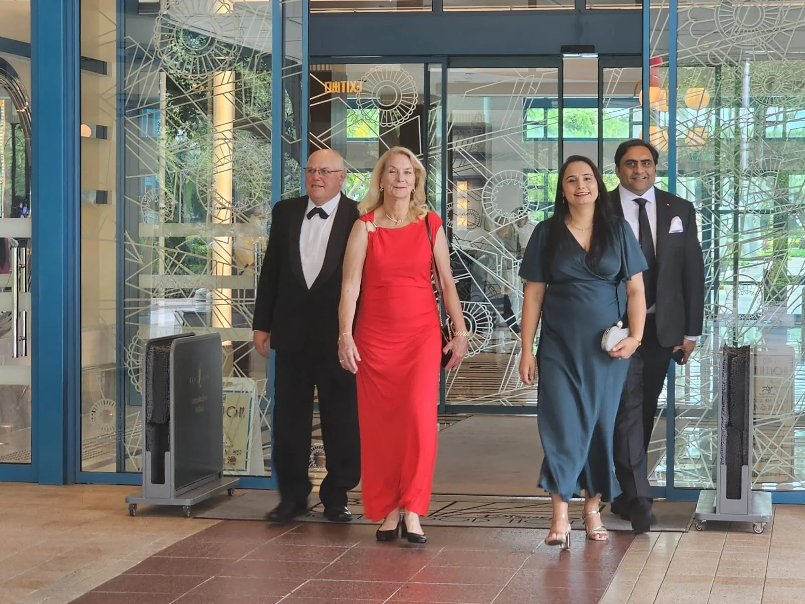 Four people arrive at the FLUXX Awards gala, showcasing professional development and event attendance.