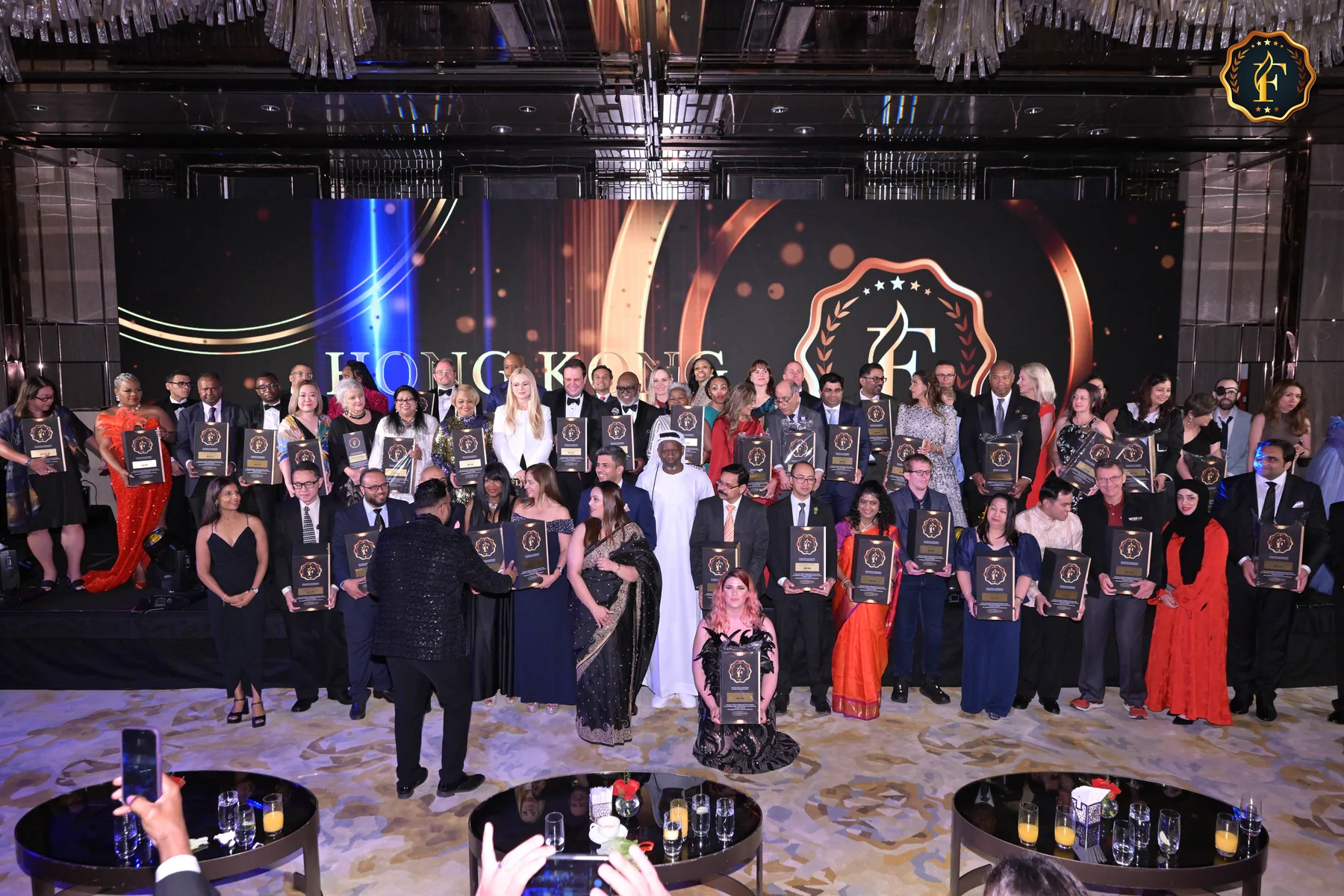 A group of award winners celebrate at the FLUXX Awards Hong Kong event, showcasing Sukh Sandhu's recognition.