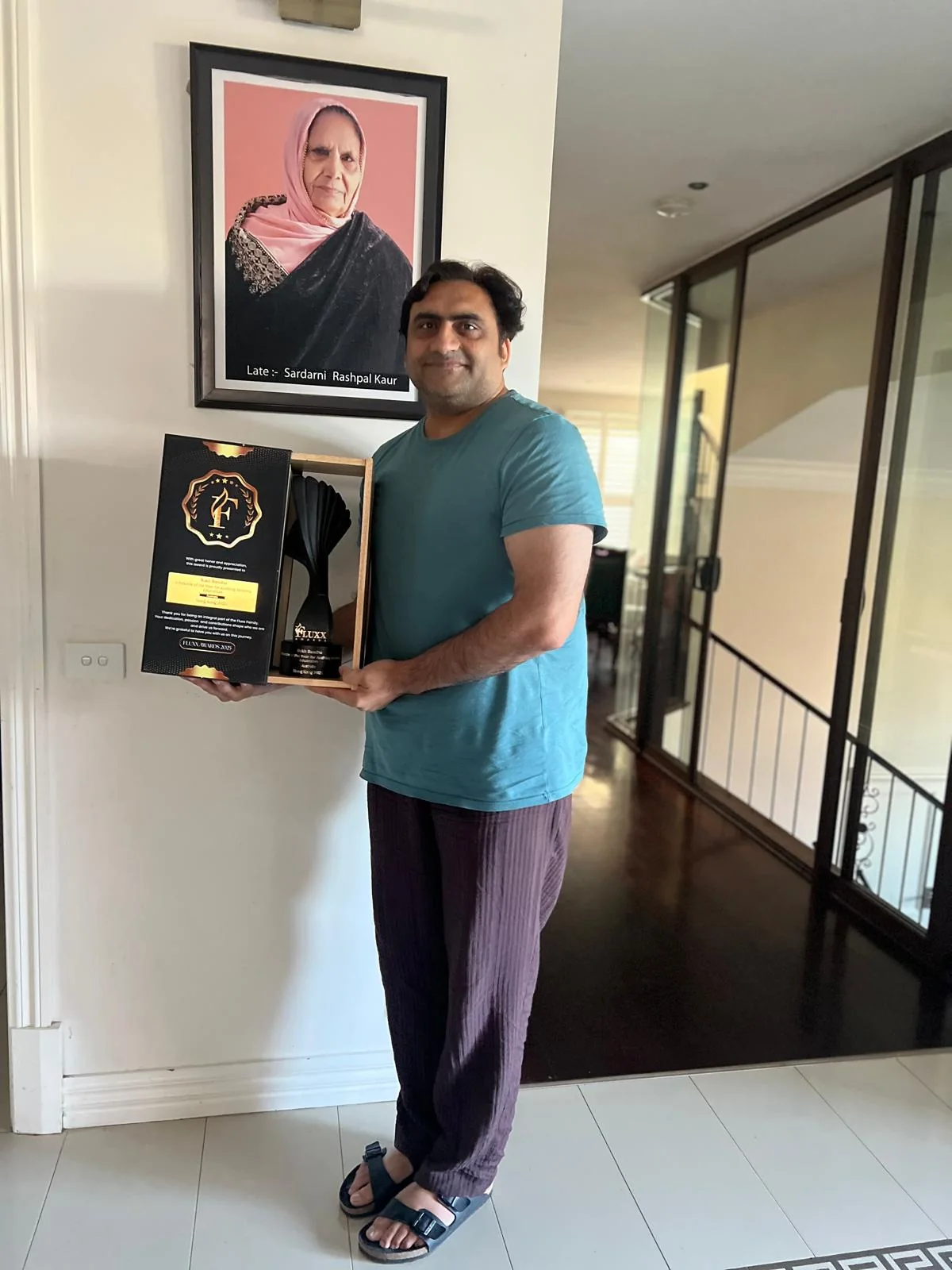 Sukh Sandhu with the FLUXX award, honouring Late S. Sardarni Rashpal Kaur.