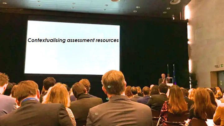 Assessment Resources | Sukh Sandhu Audience members view a presentation slide about contextualising assessment resources during compliance training.