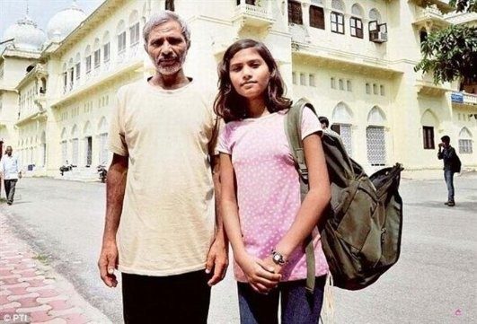 Father & Daughter | Sukh Sandhu A father and daughter stand outside a building, representing Sukh Sandhu's belief that everything is possible.