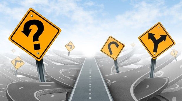Road Junction | Sukh Sandhu A graphic shows a road splitting into multiple paths with question marks and signs, representing decision making in.