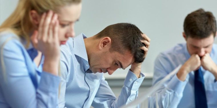Team Discussion | Sukh Sandhu Three businesspeople appear overwhelmed while discussing concerns about the national VET regulator ASQA and compliance.