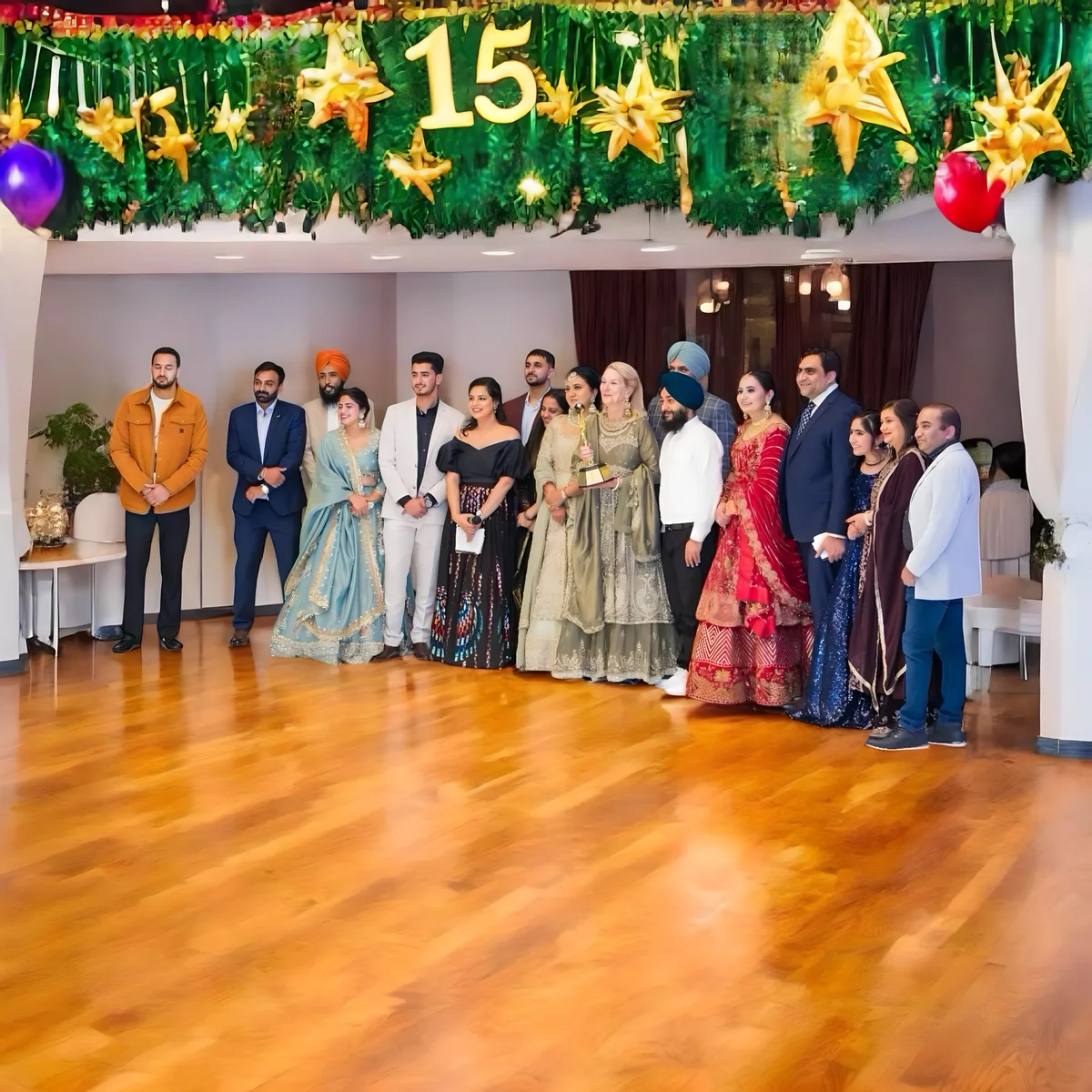 A group poses for a photo during a celebration, showcasing Sukh Sandhu's work in compliance.