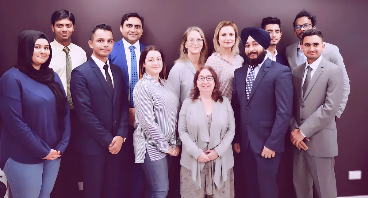 A group of professionals poses for a formal portrait, showcasing Sukh Sandhu's work in governance risk management.