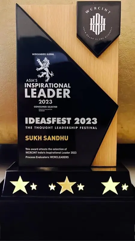 Sukh Sandhu receives a WCRCINT Asia's Inspirational Leader award at IDEAFEST 2023, demonstrating recognition for quality.